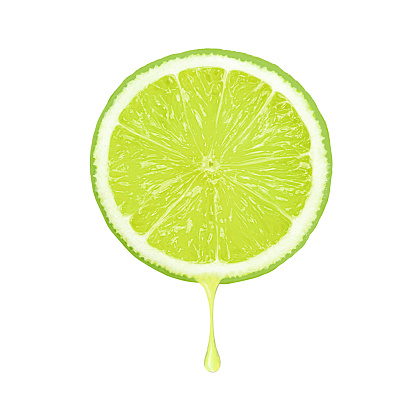 Half sliced of green lime fruit with juice dripping isolated on white background.