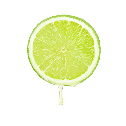 lime fruit with juice dripping isolated on white background.