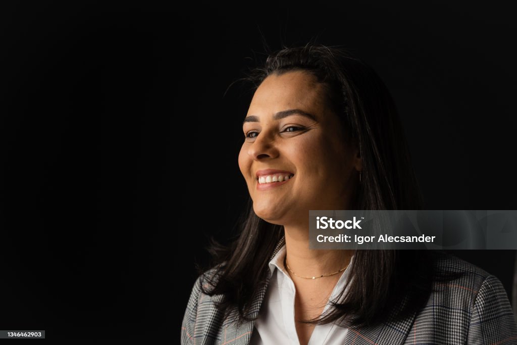 Smiling female white collar worker smiling business woman Black Background Stock Photo