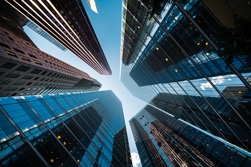 Business and finance concept, looking up at high rise office buildings in the financial district of a modern metropolis.