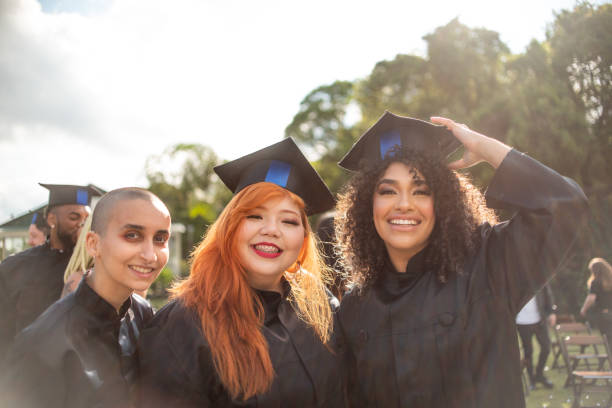 istock Portrait of three graduates on graduation day 1346471394