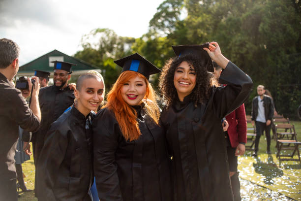 istock Portrait of three graduates on graduation day 1346471402