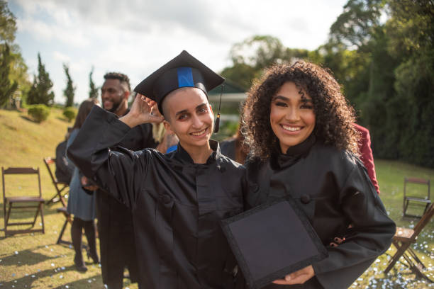 istock Portrait of two graduates on graduation day 1346471408