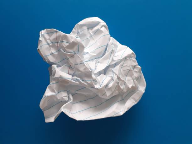 istock Crumpled paper on blue stock photo 1346478201