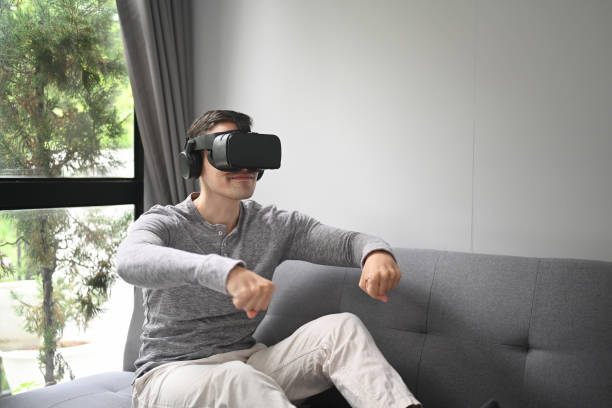 istock Young man laying video games in virtual reality glasses. 1346480312