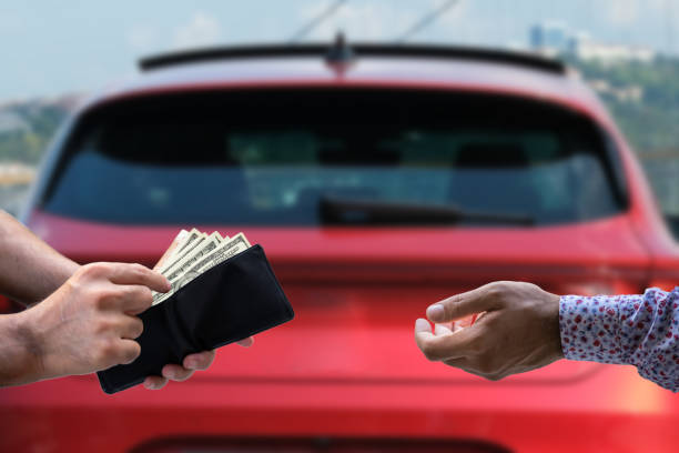 human hand paying cash human hand paying cash, selective focus. cash for cars stock pictures, royalty-free photos & images