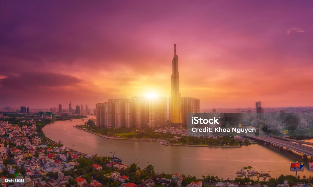 Aerial sunset view at Landmark 81 is a super tall skyscraper in center Ho Chi Minh City, Vietnam Aerial sunset view at Landmark 81 is a super tall skyscraper in center Ho Chi Minh City, Vietnam and Saigon bridge with development buildings, energy power infrastructure. Ho Chi Minh City Stock Photo