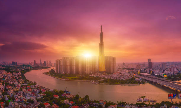 Aerial sunset view at Landmark 81 is a super tall skyscraper in center Ho Chi Minh City, Vietnam Aerial sunset view at Landmark 81 is a super tall skyscraper in center Ho Chi Minh City, Vietnam and Saigon bridge with development buildings, energy power infrastructure. ho chi minh city photos stock pictures, royalty-free photos & images