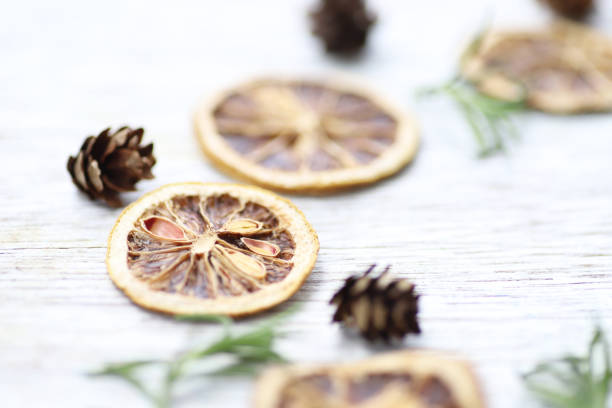istock Dried lemon slices, rosemary and cedar redwood nuts, background image 1346481215