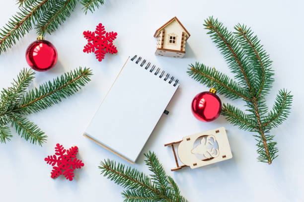 istock New Year's or Christmas background with holiday Decorations with a notebook page. top view. flat lay. mockup. 1346483483