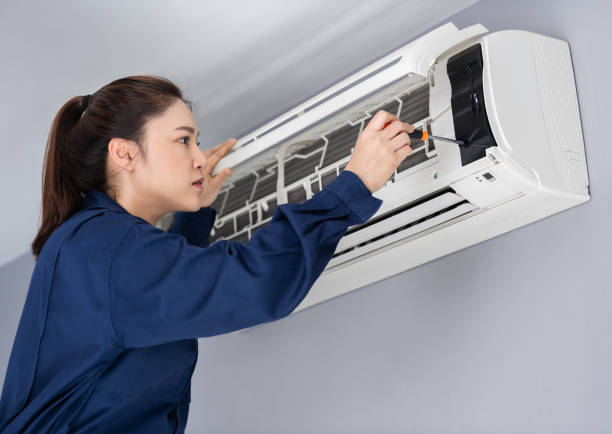 istock female technician service using screwdriver to repairing air conditioner indoors 1346484721