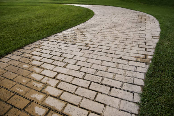 istock Cobblestone road in the grass 1346485831