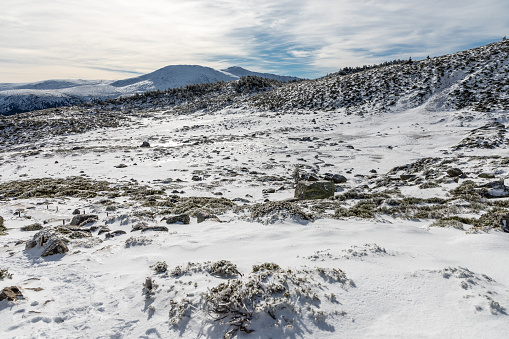 surroundings of the Lagunas de Peñalara covered by snow and ice in the mountains of the Sierra de Guadarrama, Madrid, Spain