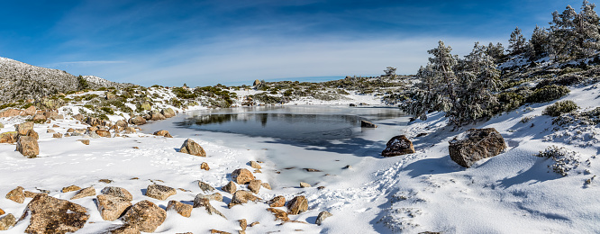 Lagunas de PeÑalara covered by snow and ice in the mountains of the Sierra de Guadarrama, Madrid, Spain