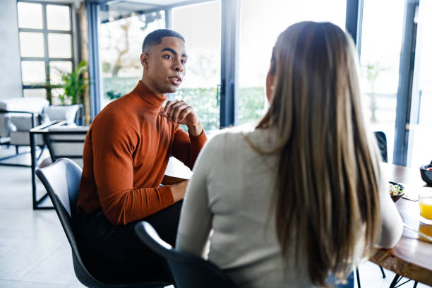 istock Young couple talking during meal in dining room. 1346491092