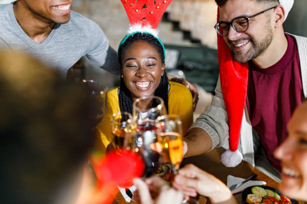 istock Cheerful friends having fun while toasting during Christmas party at home. 1346492369