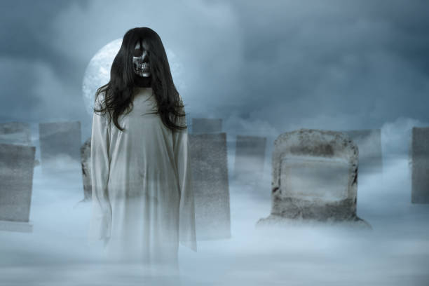 istock Scary ghost woman standing with a graveyard background 1346494474
