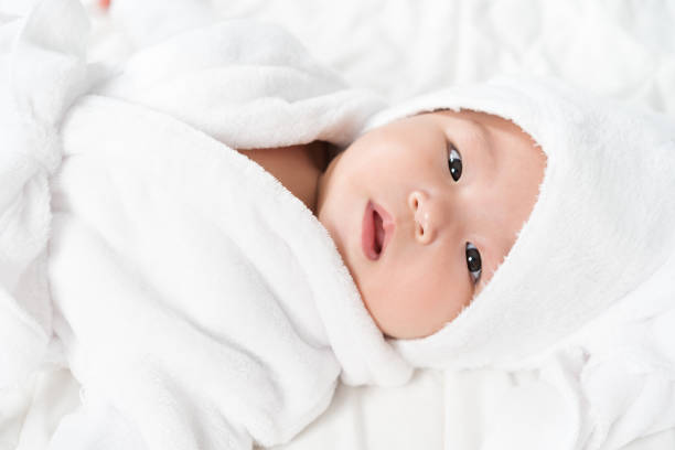 istock close up baby in soft bathrobe on bed 1346494536