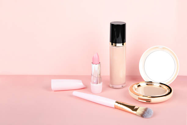 istock makeup cosmetics.  powder, foundation, lipstick on a light pink background 1346495232
