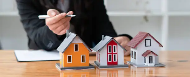 Photo of The real estate agent is explaining the house style to the clients who come to contact to see the house design and the purchase agreement.