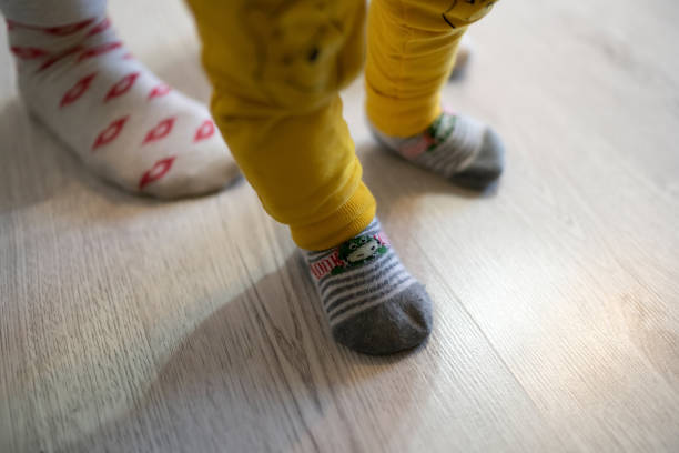 istock Mother teaches little boy infant son to walk 1346496363