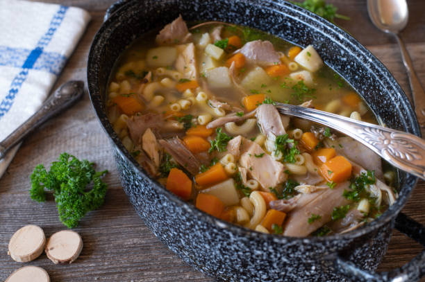 Fortifying chicken soup in a pot stock photo
