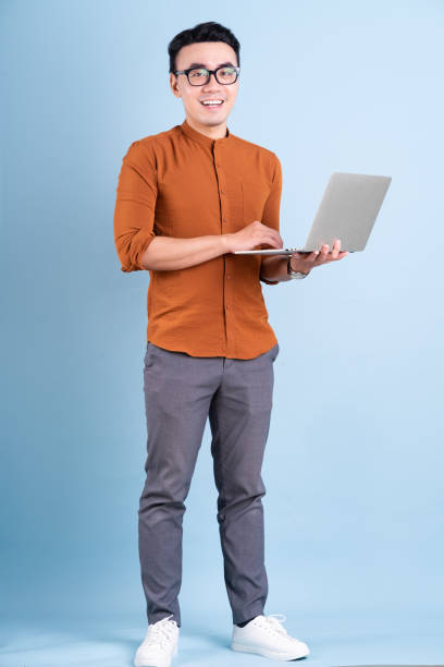 Asian man Young Asian businessman posing on blue background only young men stock pictures, royalty-free photos & images