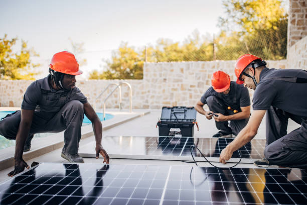 istock Solar panels installers working together 1346508360