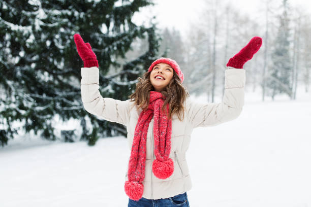 istock happy young woman in winter park 1346510524