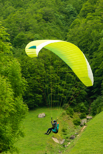 Wasserauen, Appenzell, Switzerland, June 13, 2021 Parachute is gliding through the sky in the swiss alps
