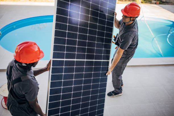 istock Men carrying solar panels 1346512386