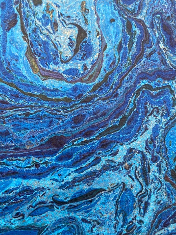 blue marbled paper with ink dye and gold - abstract ocean style background