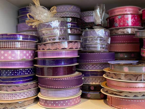 istock purple and pink ribbon rolls reels background 1346513732