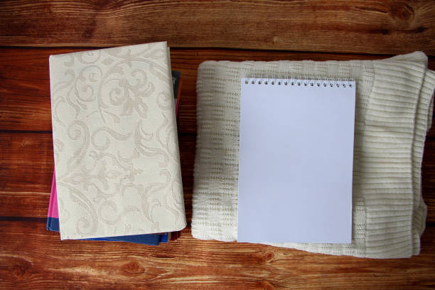 istock Notepad with a copy space for text, a stack of books and a warm sweater beside 1346514007