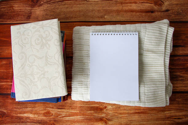istock Notepad with a copy space for text, a stack of books and a warm sweater beside 1346514008