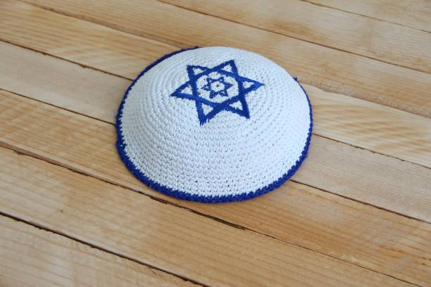 Jewish kippah hat with star of David on wooden background Jewish kippah hat with star of David on the wooden background yarmulke photos stock pictures, royalty-free photos & images