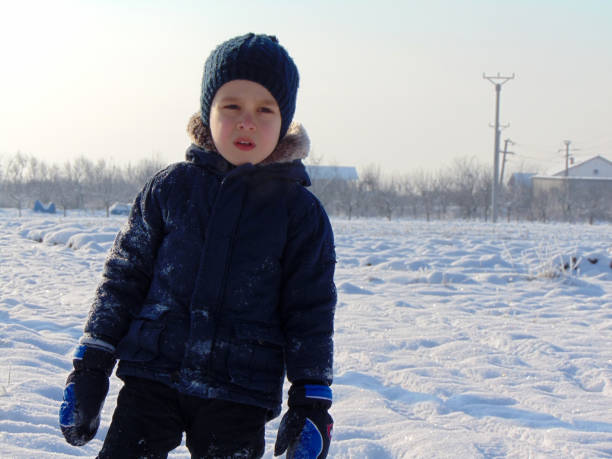 istock a little boy is playing in the snow 1346516907