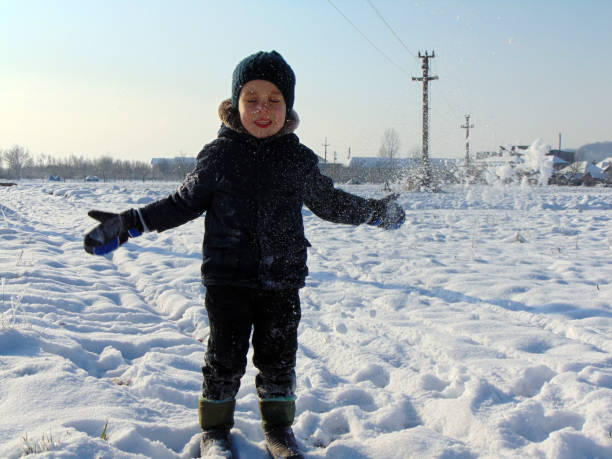 istock a little boy is playing in the snow 1346516919