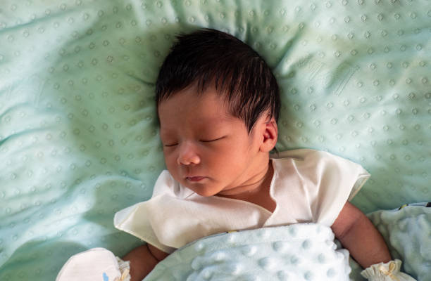istock baby sleeping on turquoise mattress 1346517435
