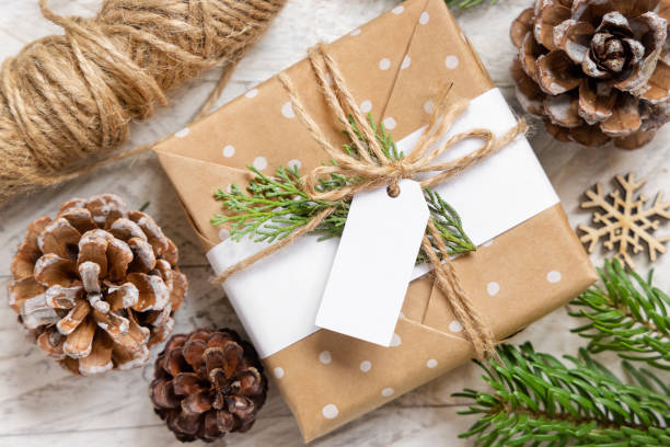 istock Christmas present with blank gift tag top view, Mockup 1346519059