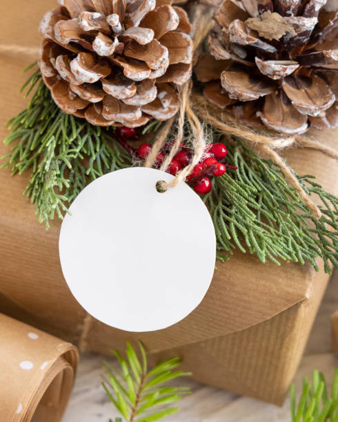 istock Christmas present with round blank gift tag close up, Mockup 1346519061