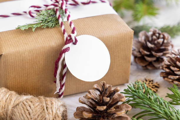istock Christmas present with round blank gift tag close up, Mockup 1346519062