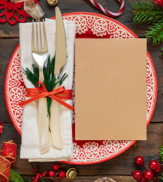 istock Festive table setting of with fir tree branches and Christmas decorations. Greeting card mockup 1346519089