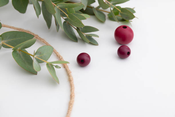 istock Beads and eucalyptus are close up. The process of creating a decorative autumn wreath. 1346519921