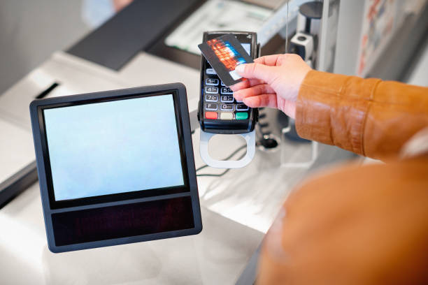 istock Holding credit card on the reader by signature pad on the counter 1346520556