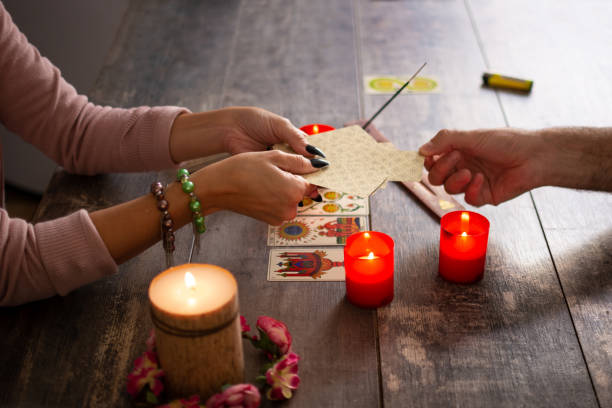 istock Fortune teller reading a future by tarot cards 1346521623