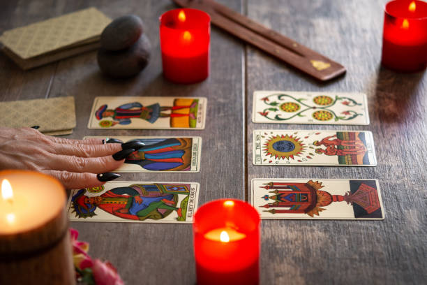istock Fortune teller reading a future by tarot cards 1346521673