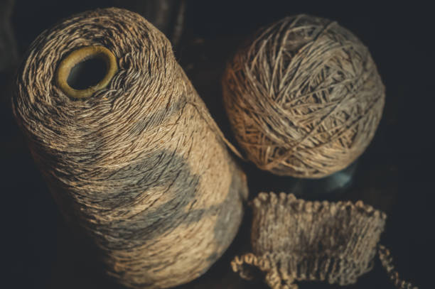 Bobbin yarn, with a ball and a started knitting project. Yarn for knitting. Horizontal composition, black background. High quality photo