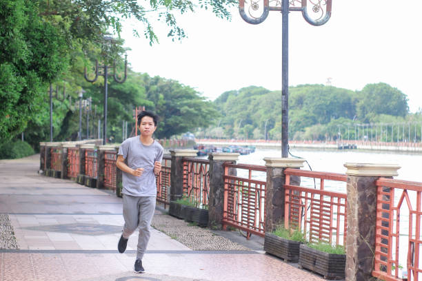 istock Young men doing exercise at a public park during a sunny day 1346524712