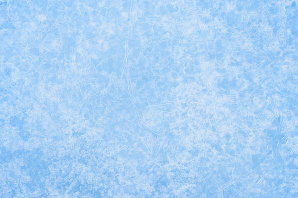 istock White openwork pattern of ice veins and frost on a blue background in uniform light. Background 1346527387